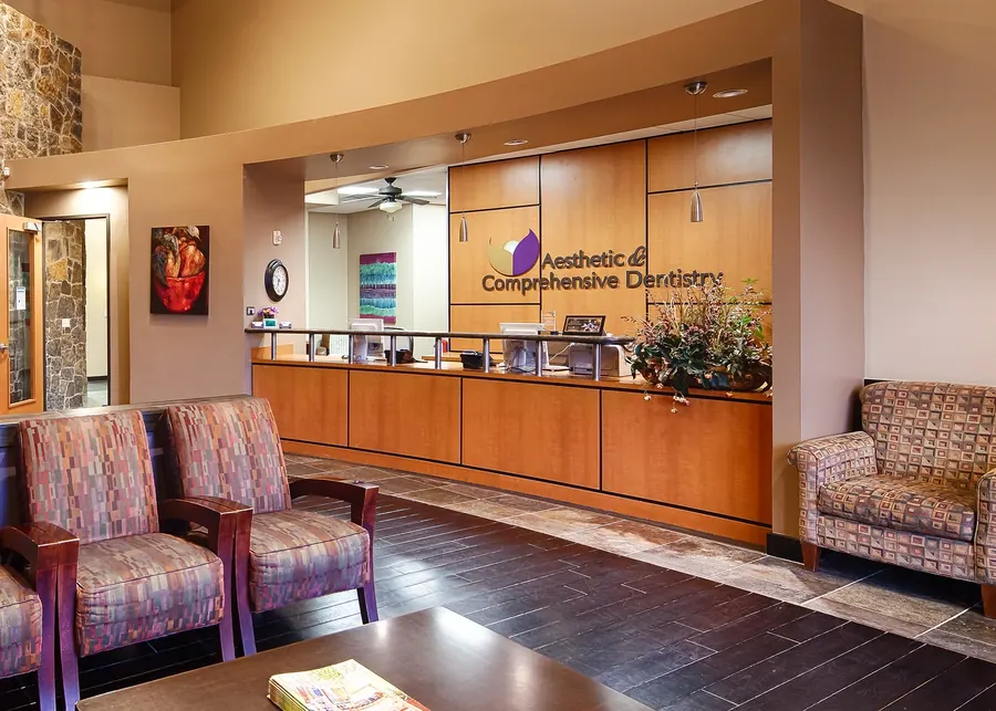 The front desk, with the practice's logo on the wall behind it.