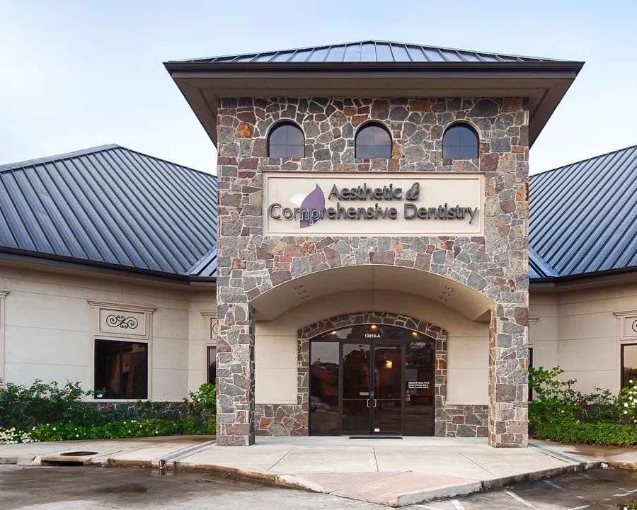 The entrance at 13810-A John Audubon Parkway, under the stone tower.